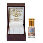 A natural perfumer delicately blending dark, viscous Cocoa Absolute Oil to create a luxurious, chocolate-scented gourmand botanical fragrance.