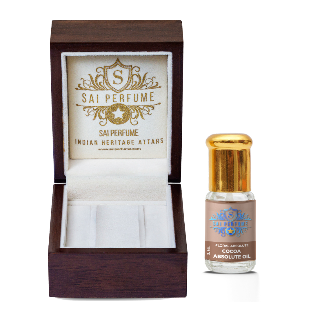 A natural perfumer delicately blending dark, viscous Cocoa Absolute Oil to create a luxurious, chocolate-scented gourmand botanical fragrance.