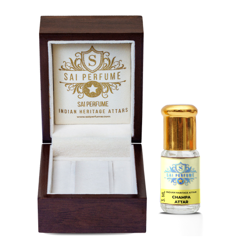 Applying natural Champa Attar perfume oil to the wrist, highlighting the rich, floral, and alcohol-free Champaca fragrance.