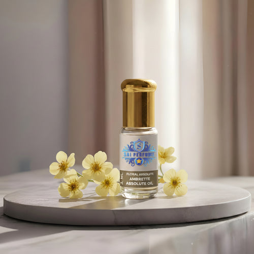 A clear glass bottle of 100% Pure Ambrette Absolute Oil by Sai Perfume, showcasing the pale yellow, botanical vegan musk extracted from Abelmoschus moschatus seeds.