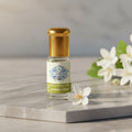 Pure Jasmine Attar perfume oil bottle by Sai Perfume, showcasing the deep orange-red, 100% natural, alcohol-free floral fragrance.