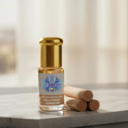 A luxury bottle of 100% Pure Malayagiri Chandan Attar by Sai Perfume, showcasing the rare golden Santalum album oil from the hills of Odisha.