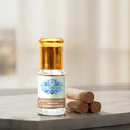 A luxury glass bottle of 100% Pure Mysore Sandalwood Attar Oil by Sai Perfume, showcasing authentic, golden Santalum album extract.