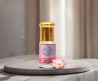 A premium glass vial of pure Pink Lotus Absolute Oil by Sai Perfume, gracefully surrounded by radiant, sacred pink lotus flowers resting on a serene water reflection.